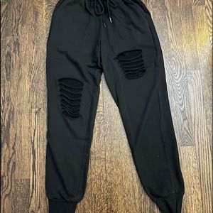 black sweatpants with rip design